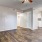 a room with a wood floor and a ceiling fan