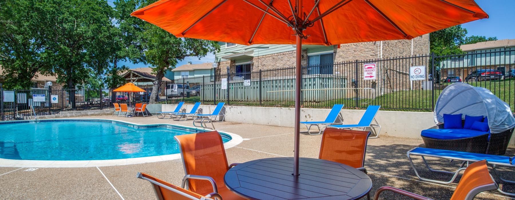 a pool with chairs and umbrellas