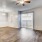 a room with a wood floor and a ceiling fan