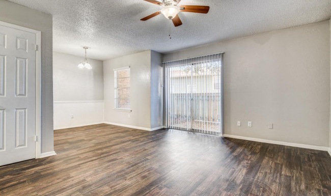 a room with a wood floor and a ceiling fan