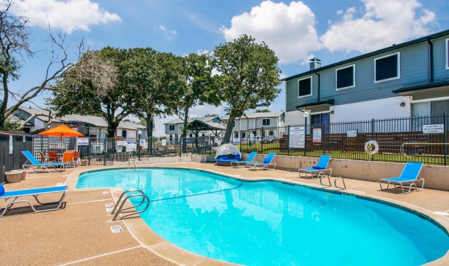 a swimming pool with chairs around it